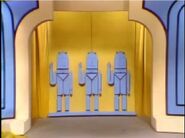Door from the 1969-1978 version during the use of the "Blocky Blue" set. The men are now props as opposed to being painted on. Door still slide spilts and resembles a curtain, notice there are curtains on the left and right sides.