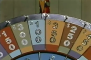 The much-too-glittery stand-up Wheel. The intro used a slightly different layout with no "special" spaces and a top value of $450.