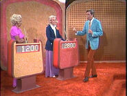 The Showcase podiums from a 1972 episode. That's memorable contestant Boo Boo Cooper on the left. The yellow podium is on the left and the orange podium is on the right. The posts are colored brown.