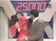 Password’s all-time biggest winner, Natalie Steele, hugs host Bert Convy after winning the bonus round in the 1985 Tournament of Champions. She finished with $106,000.