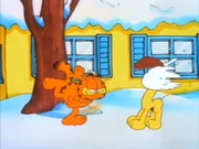Attention: Garfield hits Odie point blank with a snowball, not that the puppy cares.