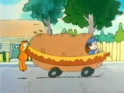 Hot Dog Truck: Garfield hangs onto a hot dog-shaped truck with his teeth.