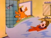 Surfing: Garfield rides an artificial wave, which Jon unleashed upon himself.