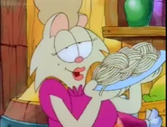 Mona with a plate of cooked pasta.