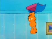 Nailed into Bed: Garfield hangs from the ceiling after getting pranked by Jon.