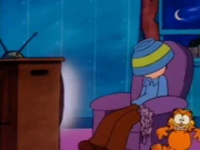 Quiet Evening: Garfield dances away after eating Jon's popcorn and scratching the chair.