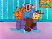 Wet Pets: After coming in from the rain, Garfield and Odie shake themselves all over Jon.