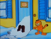 Snowball: Garfield celebrates a snowball plowing into Jon.