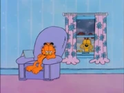 Locked Outside: Odie shivers in the snow and begs Garfield to let him in.