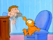 Absorb Shock: Garfield whacks Jon in the chin with the former's newly-bought jogging shoes.