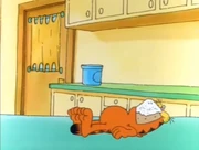 Cereal, Milk, Sugar: Garfield lies with a mouthful of cereal, milk, and sugar.