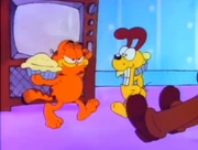 Show for Jon: Garfield and Odie prepare to throw pies in each others' faces to entertain Jon.