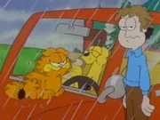 Camping: Odie happily eats a sandwich after locking Garfield and Jon out of the car.