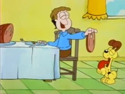 Dogs: Jon feeds Odie a big slice of ham after the pup chased his tail.