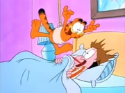 Hang in the Ceiling: Garfield bungees above Jon, surprising him in the process.