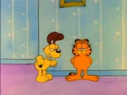 Searing Episode in the Life: Odie stands next to Garfield, seemingly ready to strike.
