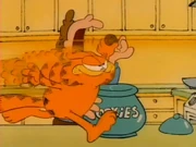 Cookies: Garfield goes Mach 3 to steal Jon's cookie.