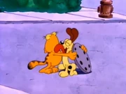 Jellybeans: Odie gives Garfield a big lick after the latter lifted a manhole cover and peeked inside.