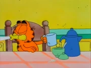 Strange Morning: Garfield spits out the sugar because he forgot to add the coffee.