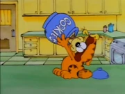 Eating Cookies: Garfield is eager to eat some cookies, but it seems that Odie has beaten him to it.