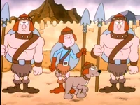 The dog passing past Jon.