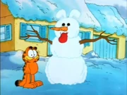 SnowOdie Man: Garfield presents his snowman to the viewers, which has Odie caught in the head.