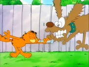 Dog Whistle: Garfield blows a dog whistle right in front of a dog.