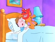 Diable: Garfield pokes Jon's head to wake him up while he wears a creepy mask.