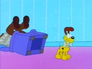 Seeking Bone 2: Odie tips Jon and his chair over and finds his bone.