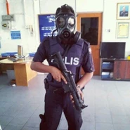 A Malaysian policeman (probably in Kulai district, at the state of Johor) wearing an S10 while holding a Bushmaster Carbon 15 - 9mm Carbine