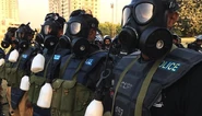 Pakistani riot police wearing their MF-11 with their canteen and drinking tube still attached to their mask.