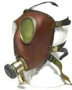 Dräger-made 1962 facepiece with connector with exhale valve and hose connection port. Note the very late pattern of exhale valve present and the rubber harness