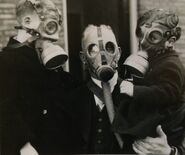 Man wearing a Model G with two children wearing Duiker masks