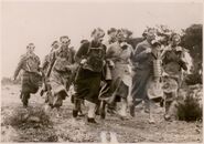 Women running with Pirelli respirators. A couple of updated pattern P43 can be seen, alongside a T.33 on the right and various hosed Pirelli masks (unidentified, probably E or EM)