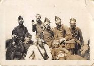 Some soldiers trying on their M.24 gas masks