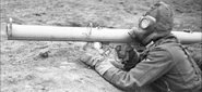 German soldier aiming with an RPzB 54 Ofenrohr while wearing a GM38.