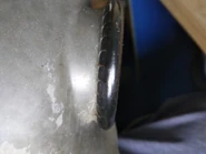 Closeup of crimped lens metal