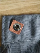 Closeup of press studs on haversack