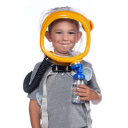 A boy holding a hydration bottle attached to the respirator