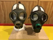 Two different coloured versions, left is size small, right is a medium size, note the mask on the left appears to be missing its exhale valve, and the mask on the right has the green filter adapter commonly sold with the mask
