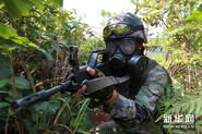 A PLA personnel wearing an MF-11 while operating a QBZ-95.