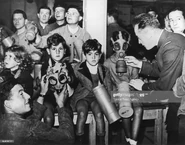 Children wearing gas masks, one of which is an Ajax F2, likely a size 4