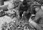 Among a pile of captured Japanese gas masks, a number of AG 20Cs and a single GM30 can be seen. It's unclear how they ended up mixed with Japanese equipment