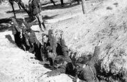 Republican soldiers training with gas masks. Note the soldier at the left wearing a Spanish T.35 copy