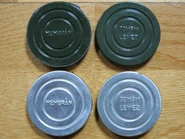 Earlier (green painted steel) and later (unpainted aluminium) spare membranes and anti-fogging inserts.