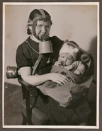 Other advertisement, mother with a S.I.P. 2 and her baby in a Pirelli baby gas hood, both using Dirzepest filters. One is orange the other is greenish blue.