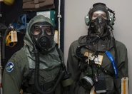 Capt. Edward Silva, of the 436th Operations Support Squadron, poses wearing an XM69 JSAM-SA next to the previous generation Aircrew mask, the AERP (Aircrew Eye Respiratory Protection) Circa: March 2nd, 2016