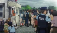 Tokyo Metropolitan Police officers escort civilians to the Imperial Palace