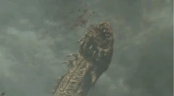 The Riftworm busting out of the ground after having its final heart severed.