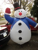 Snowman in blue coat and top hat